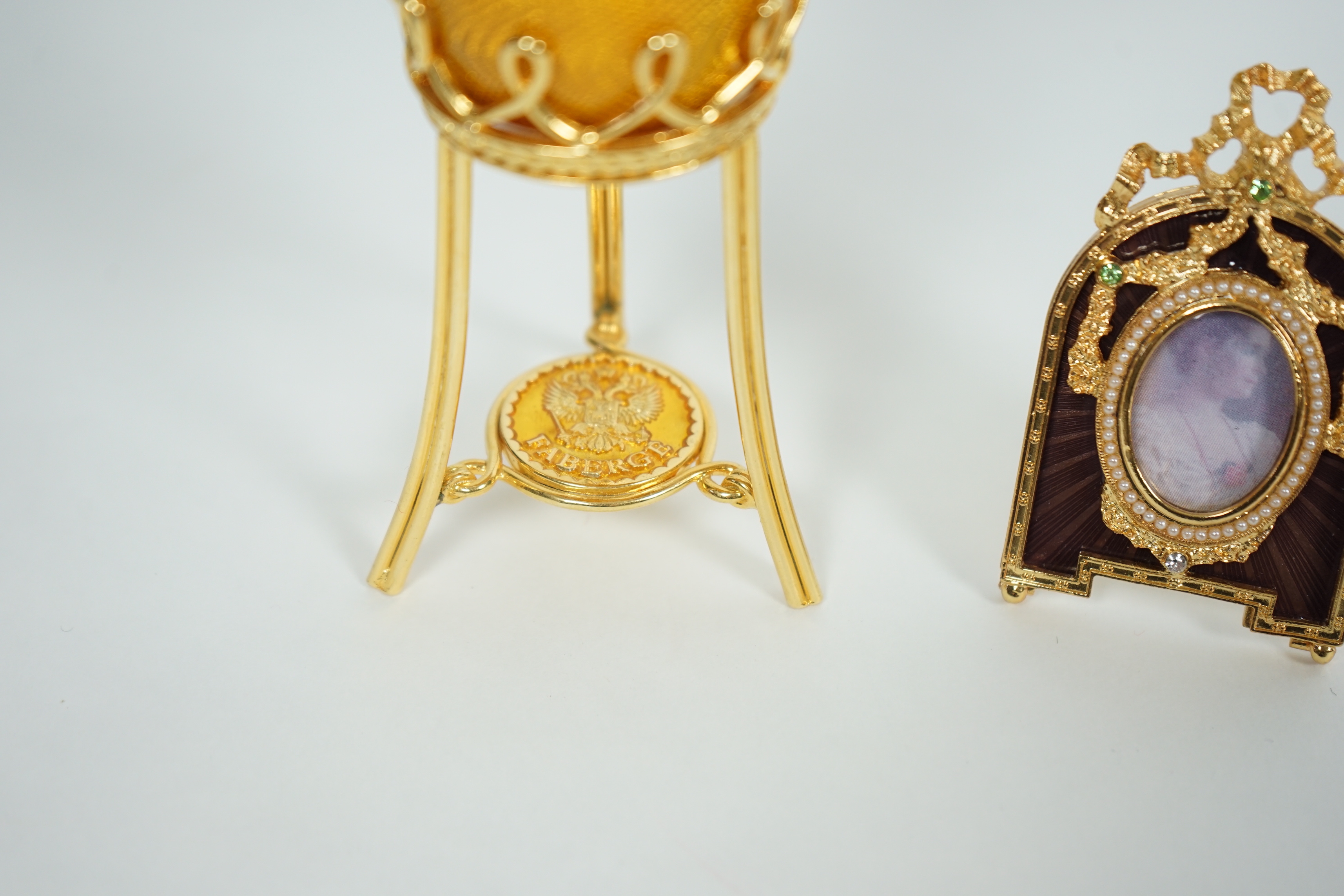 A Fabergé Imperial Collection Menagerie Rabbit Surprise Egg on stand together with a Fabergé gilt and enamel photograph frame